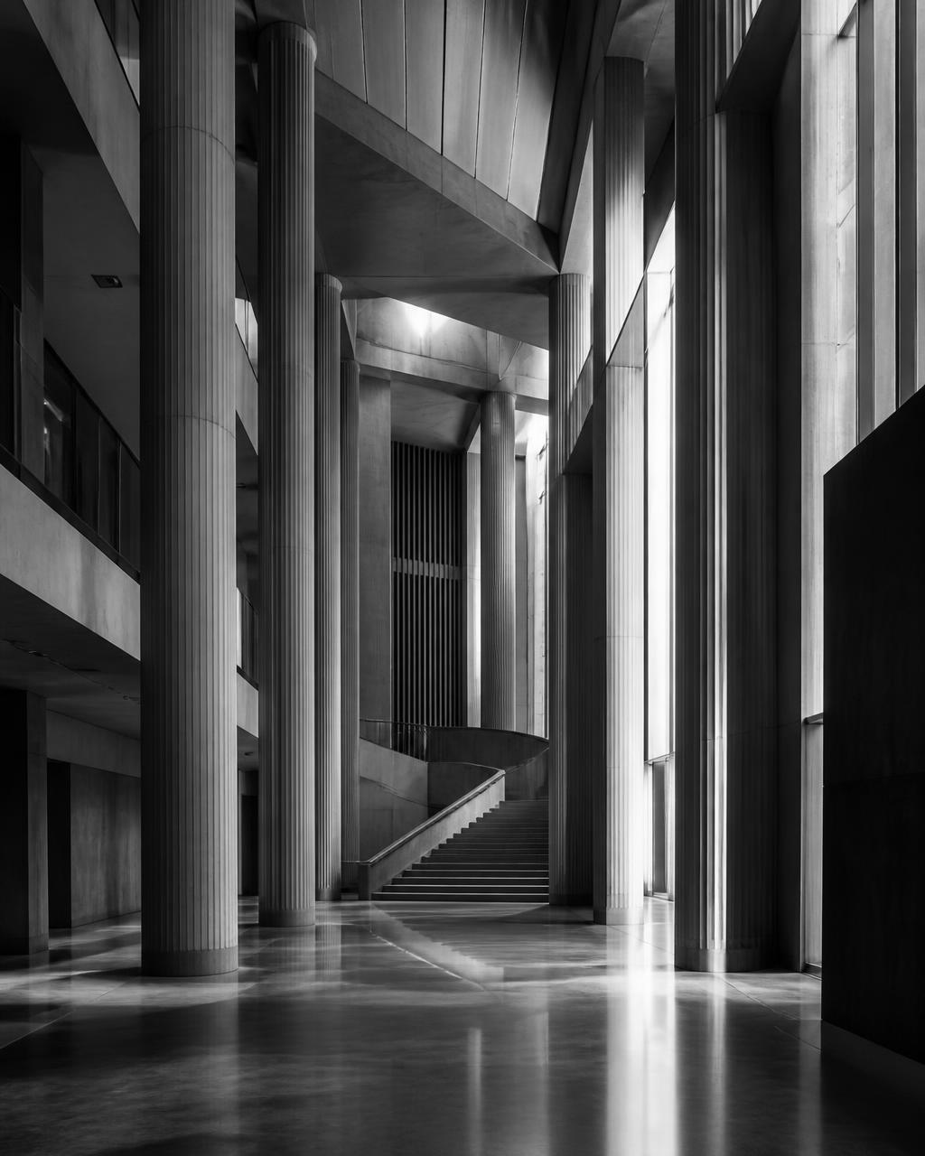 Modern UK courthouse atrium with tall concrete columns